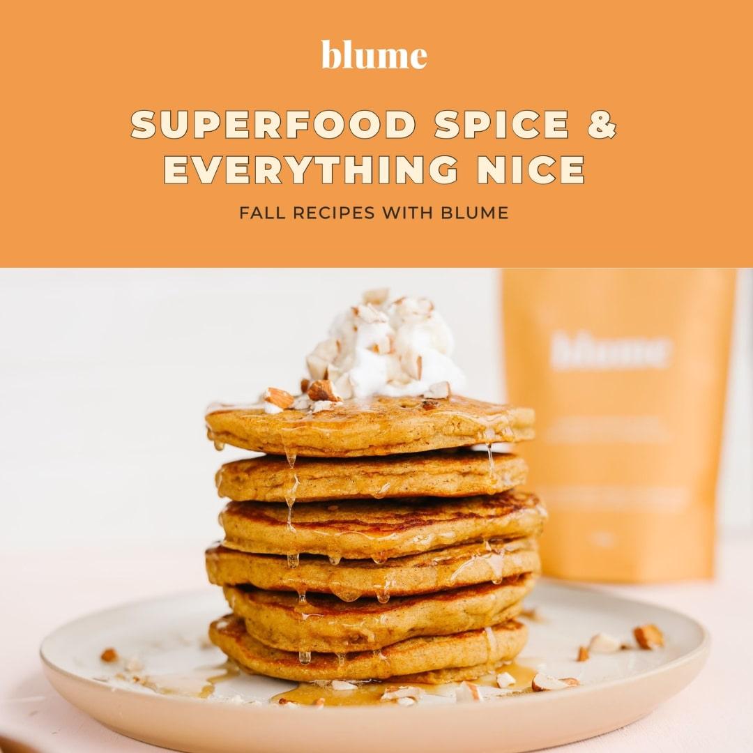 A stack of pancakes adorned with whipped cream and nuts rests elegantly on a plate, set against an orange package that highlights Blumes Our Fall Digital Recipe Book, creating a cozy atmosphere for flavorful cooking adventures and digital downloads.