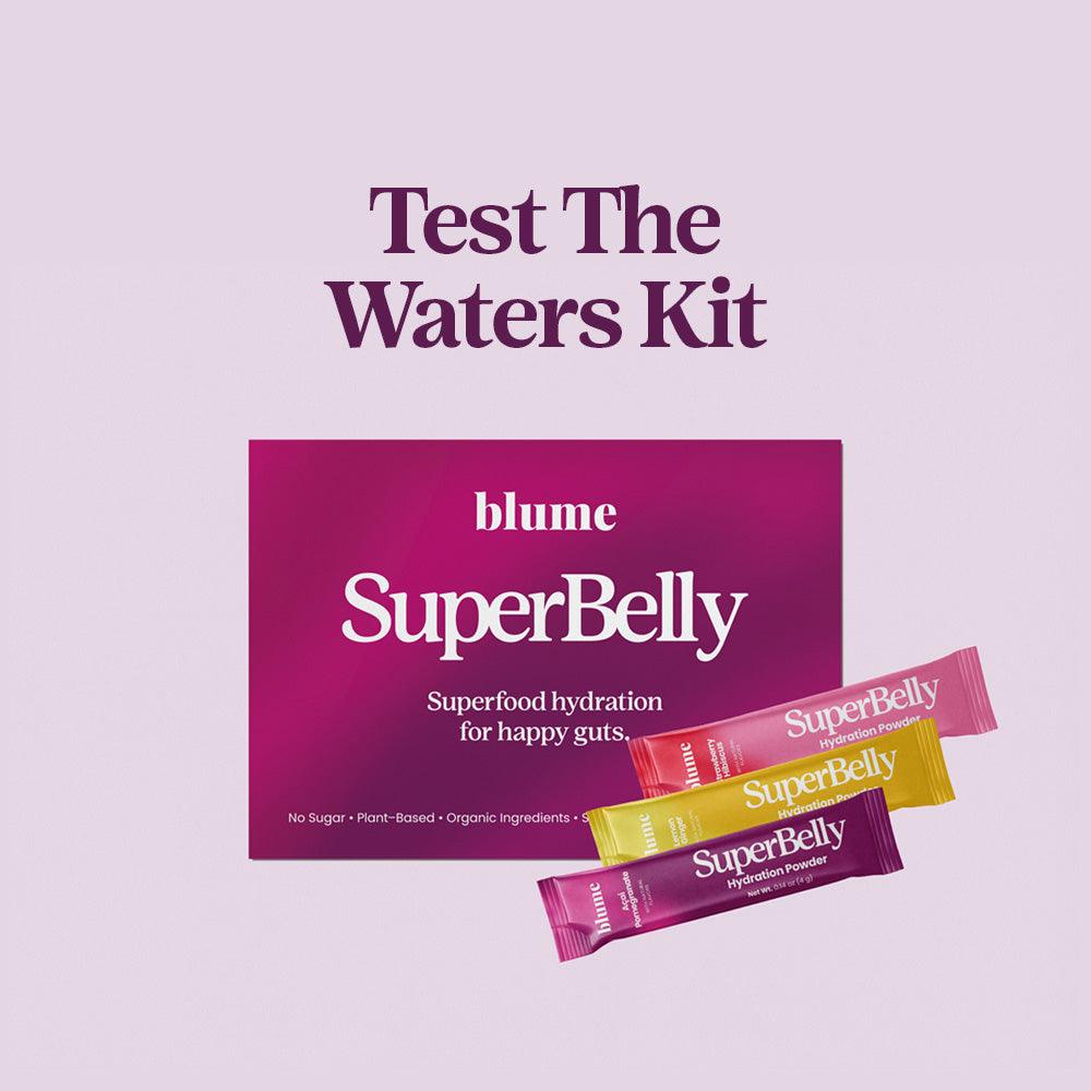 Image of Blumes Test the Waters Kit: a purple box labeled SuperBelly offering Superfood hydration for happy guts. Displayed below are packets of Acai Pomegranate and Strawberry Hibiscus, both labeled SuperBelly.