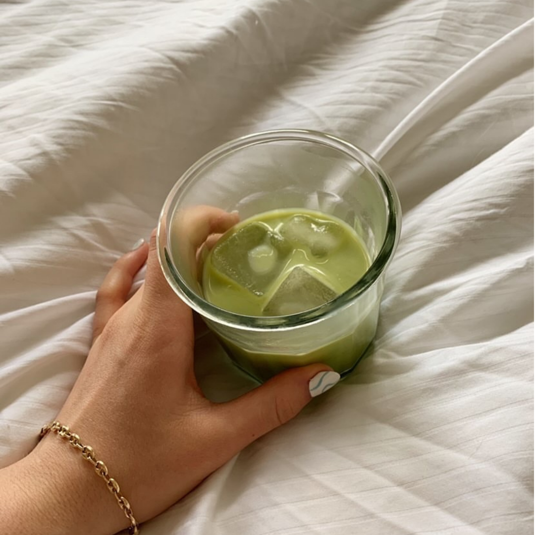 A glass of iced matcha latte made with Blume Matcha Coconut Blend taken by @brynndolfi