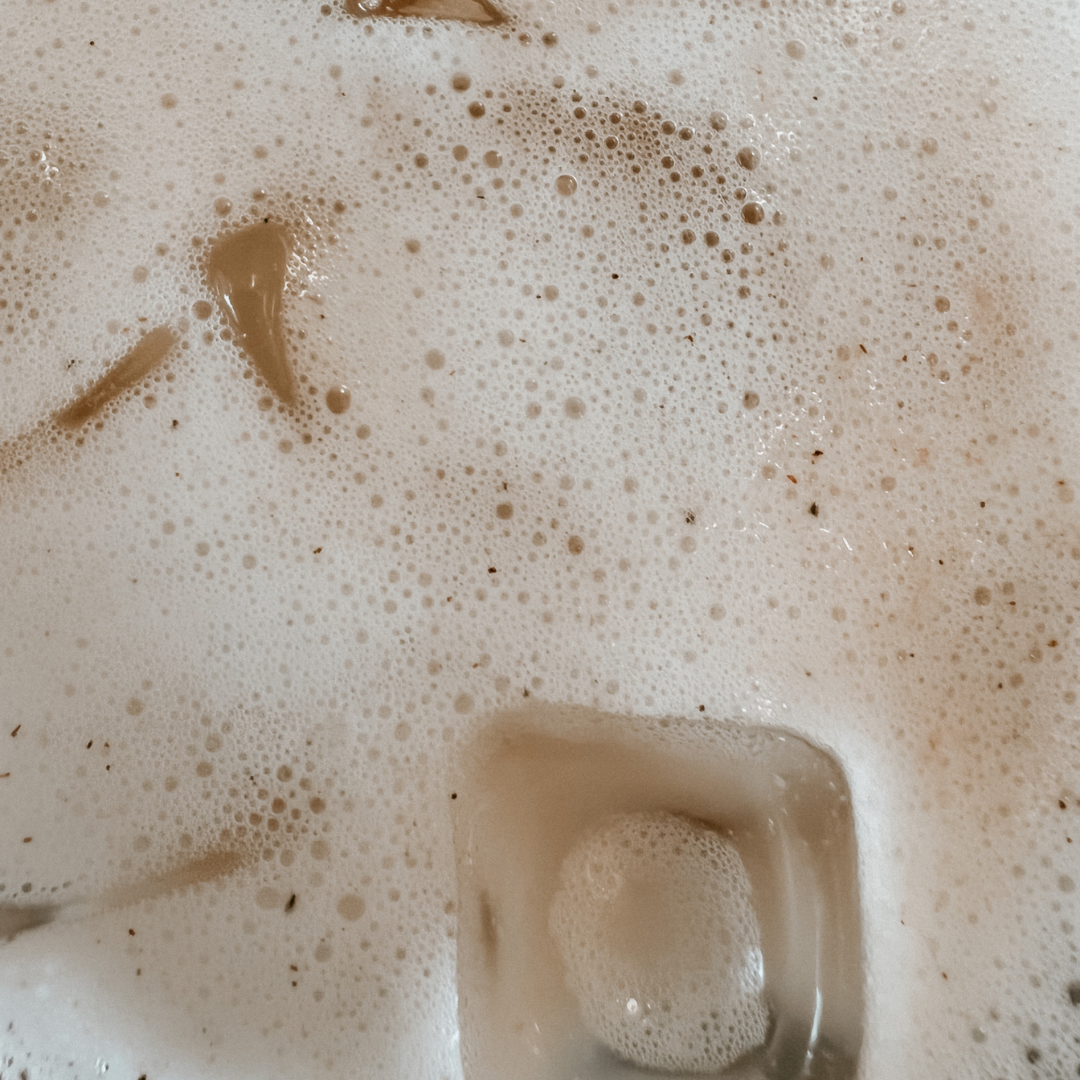 Macro image of iced blume's Rose London Fog latte with ice cubes taken by @sydneyednie