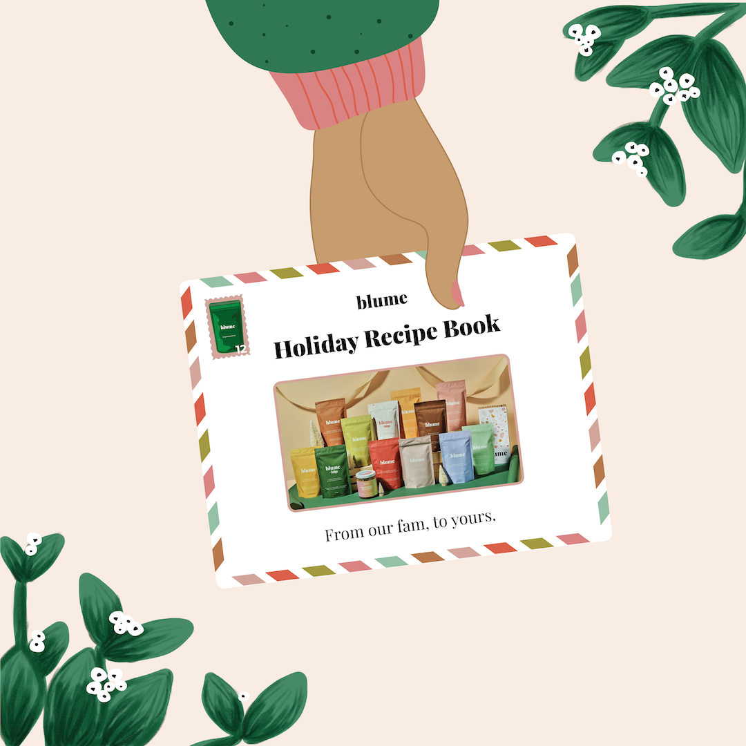 An illustration depicts a hand holding Our Holiday Recipe E-Book by Blume, surrounded by green leaves and white flowers. The cover shows colorful tubes with the text blume Holiday Recipe Book. From our fam to yours. Enjoy delights like Gingerbread and Mint Cocoa inside.