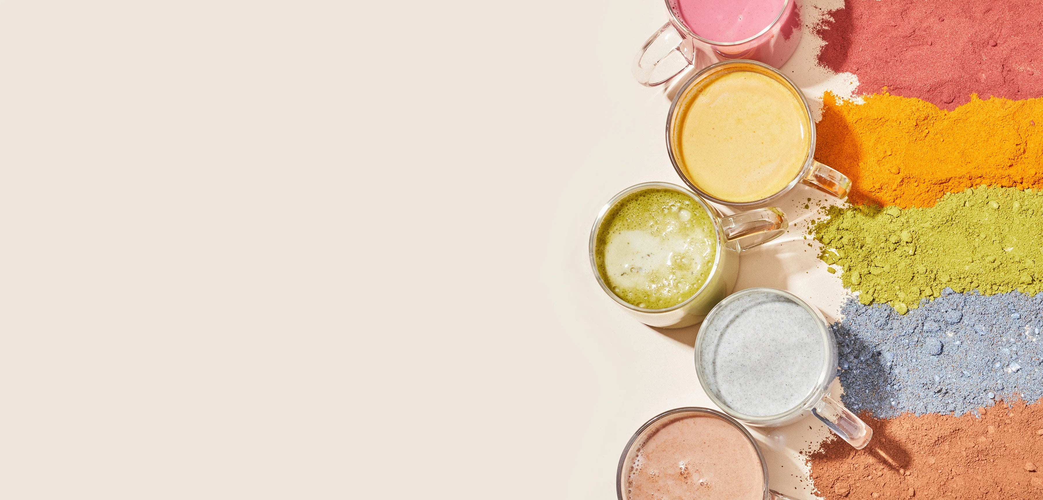 Six mugs with colorful drinks, arranged vertically on the left. Each mug is next to a pile of matching colored powder on the right, including shades of pink, peach, yellow, green, blue, and brown. The background is light beige.