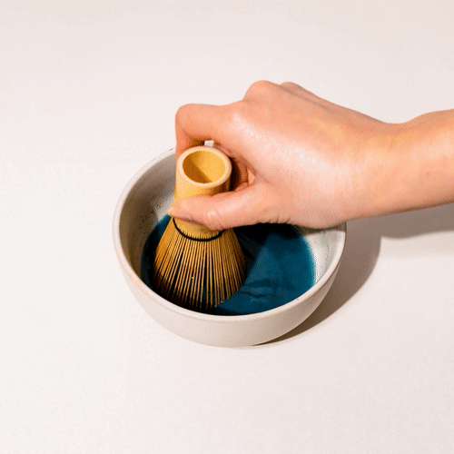 A gif of whisking a bowl of Blue Lavender Blend by bamboo whisk