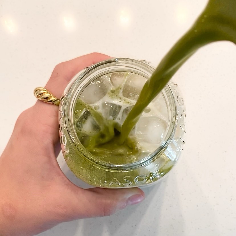 Blume's Matcha Coconut Latte pouring into a glass cup filled with ice cubes taken by @livshealthylife_